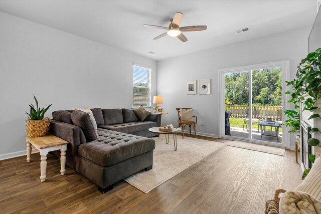 living room featuring ceiling fan, hardwood / wood-style floors, and a healthy amount of sunlight