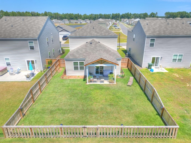 back of house featuring a lawn and a patio