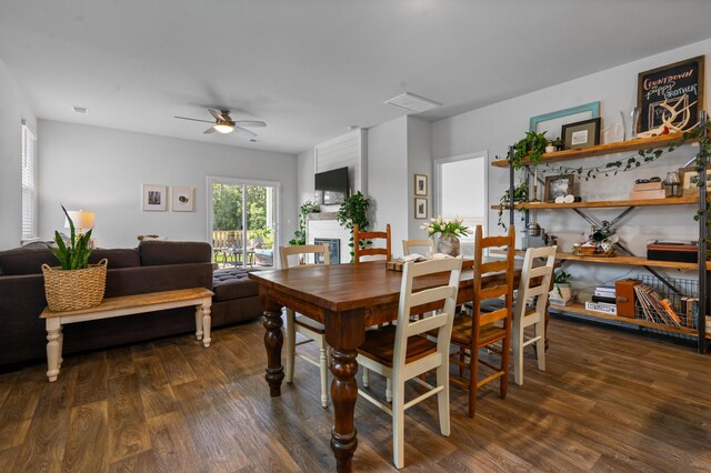 dining room with ceiling fan and dark hardwood / wood-style floors