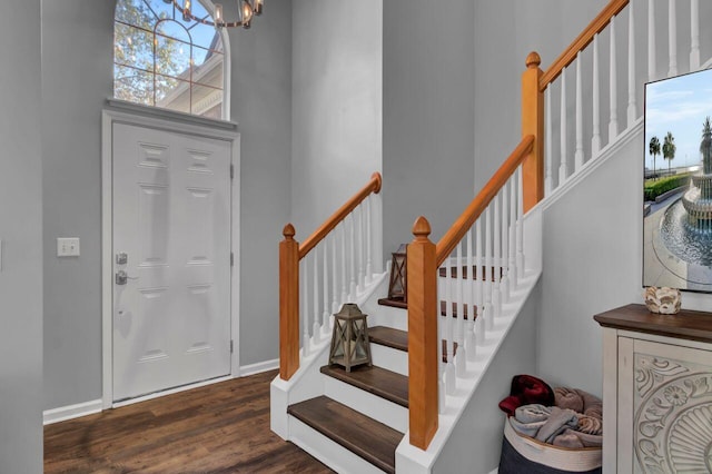 foyer entrance with a chandelier and dark hardwood / wood-style floors