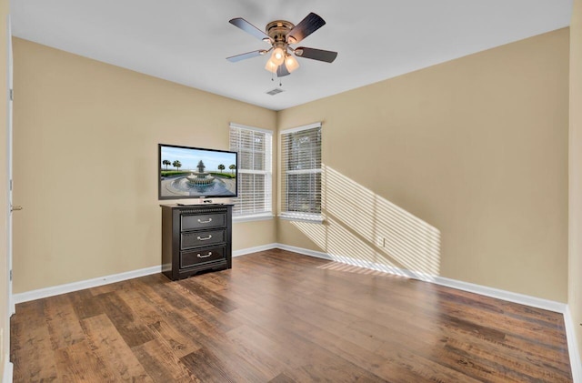 empty room featuring ceiling fan and dark wood-type flooring