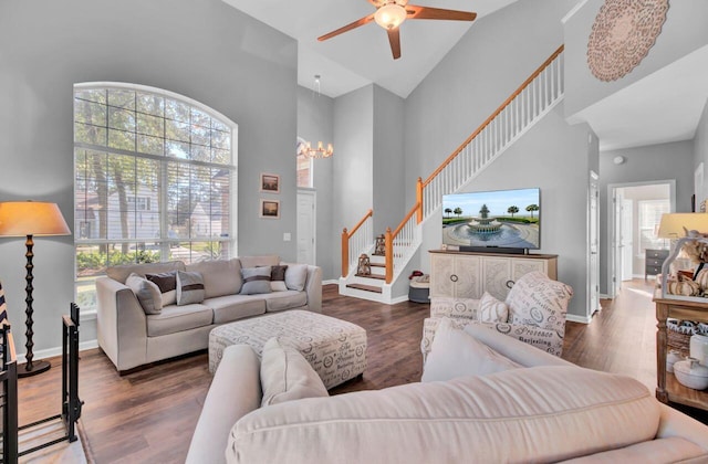 living room with high vaulted ceiling, ceiling fan, and dark wood-type flooring