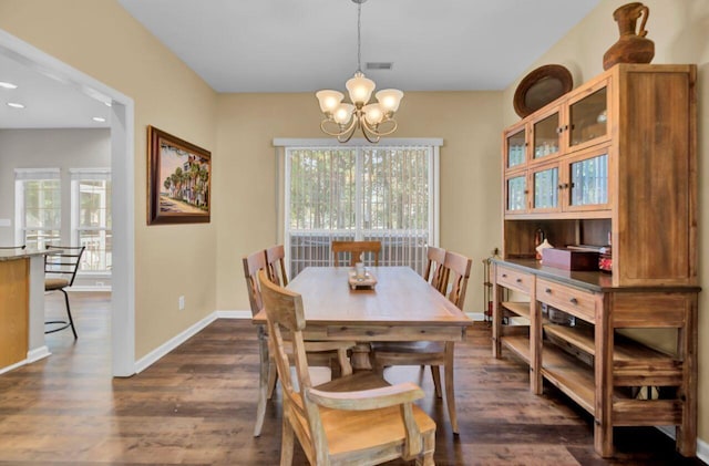 dining room featuring a notable chandelier, plenty of natural light, and dark hardwood / wood-style floors