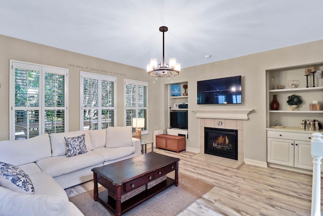 1664 William Hapton Way, Mount Pleasant, SC 29466 - living area with a chandelier, a tile fireplace, light wood-style flooring, and built in shelves