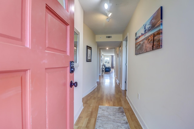 hall with light hardwood / wood-style flooring