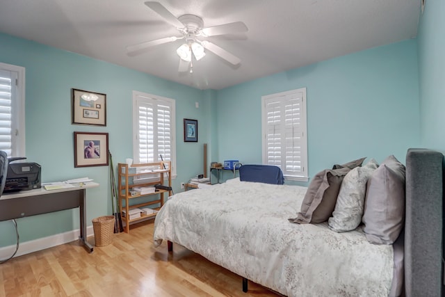 bedroom with ceiling fan and hardwood / wood-style flooring