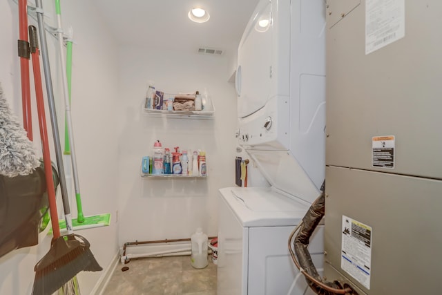 laundry area with stacked washer and clothes dryer