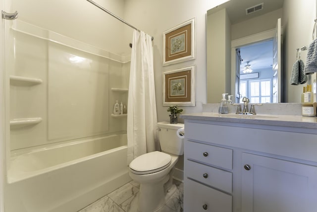 full bath featuring marble look tiles, toilet, vanity, and shower / bath combo