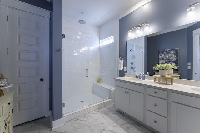 full bath with marble finish floors, a shower stall, and double vanity