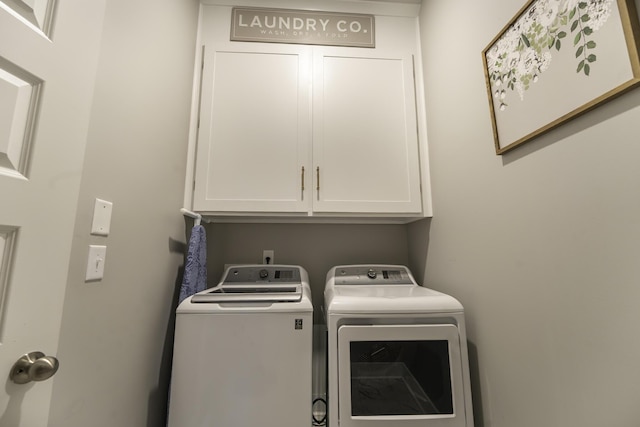clothes washing area with cabinet space and separate washer and dryer