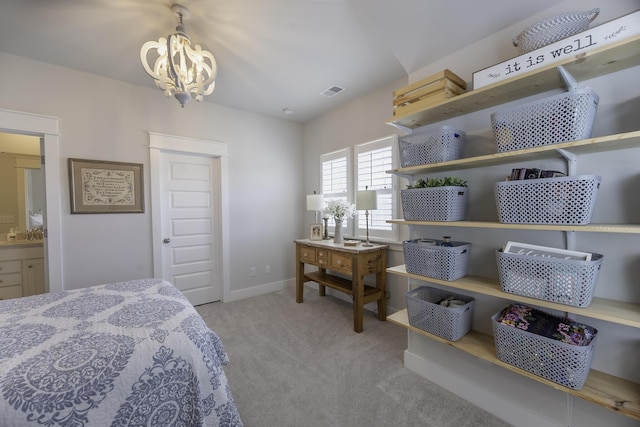 bedroom with a chandelier, carpet floors, baseboards, and a closet