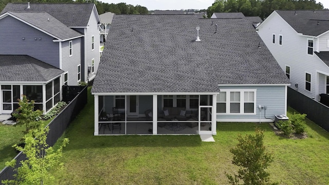 back of house with a sunroom, roof with shingles, and cooling unit