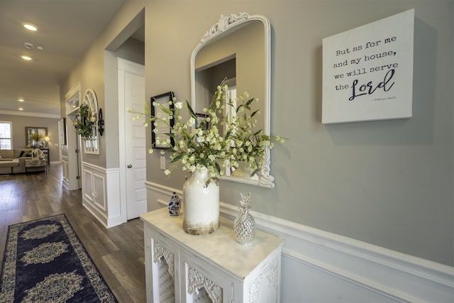 hall featuring wainscoting, dark wood finished floors, recessed lighting, and a decorative wall