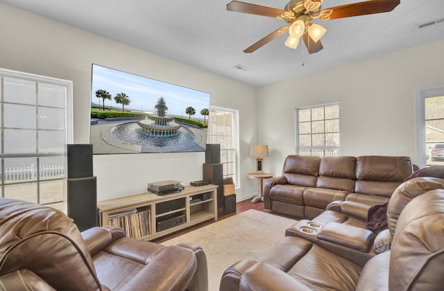 living room with hardwood / wood-style flooring and ceiling fan