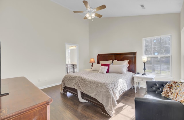 bedroom featuring ceiling fan, dark wood-type flooring, and lofted ceiling