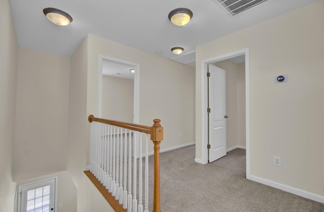 hallway featuring light carpet