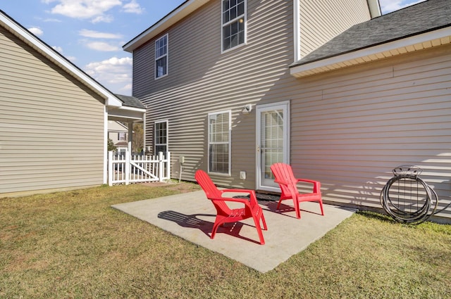 rear view of house with a patio area and a yard