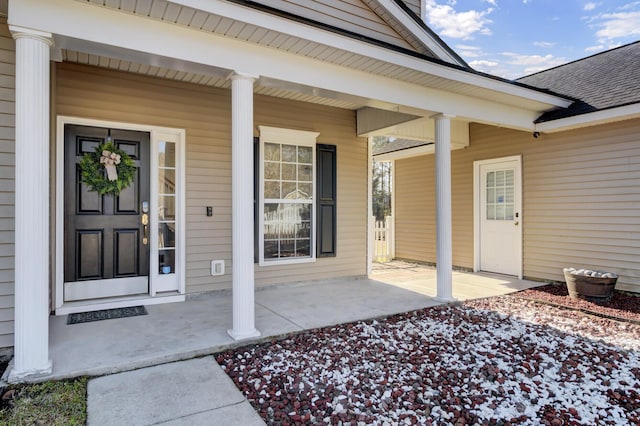 view of exterior entry with covered porch