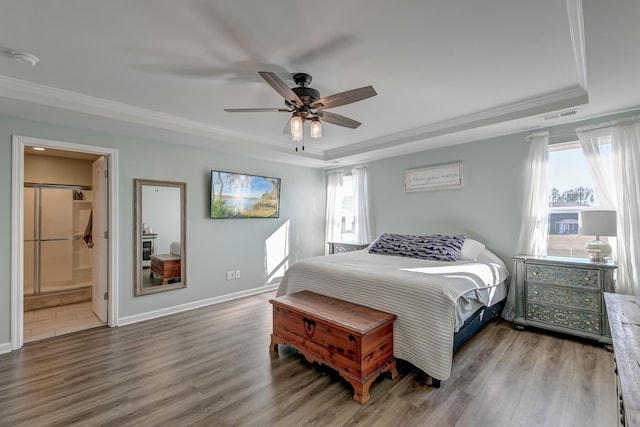 bedroom featuring hardwood / wood-style flooring, ceiling fan, crown molding, and connected bathroom