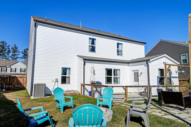 back of property featuring a yard and central AC unit