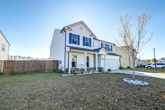 view of front of home featuring a front lawn, a porch, and a garage