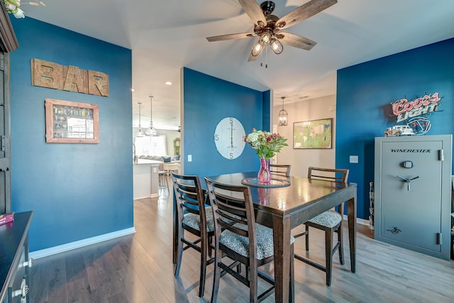 dining area with ceiling fan and hardwood / wood-style flooring