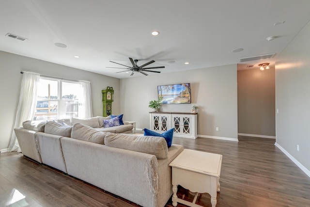 living room with ceiling fan and dark hardwood / wood-style floors