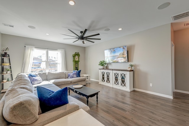 living room featuring hardwood / wood-style floors and ceiling fan