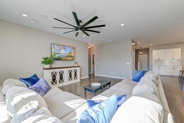 living room featuring ceiling fan and wood-type flooring