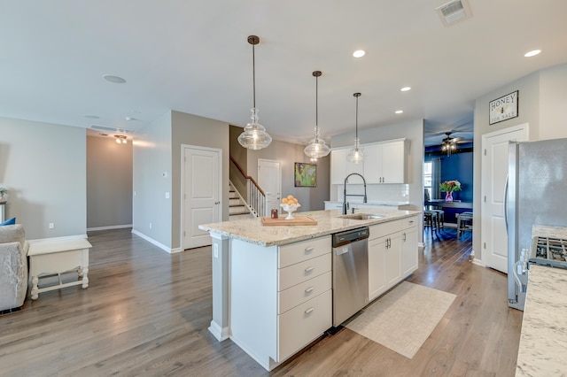 kitchen featuring white cabinetry, sink, ceiling fan, and appliances with stainless steel finishes