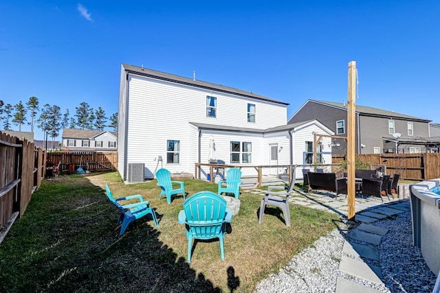 rear view of property with outdoor lounge area, cooling unit, and a lawn