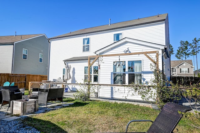 rear view of house featuring a yard