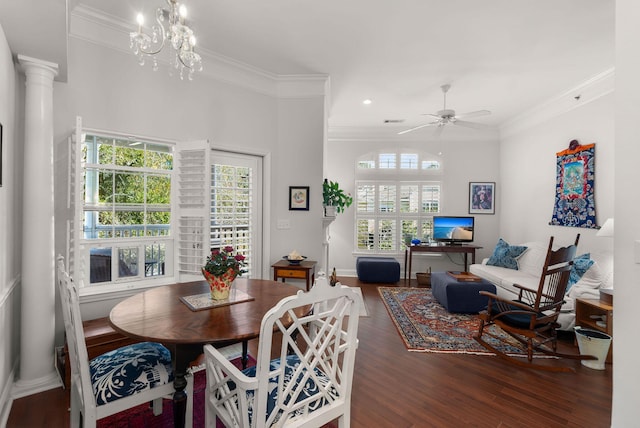 dining room featuring ornamental molding, dark hardwood / wood-style floors, ceiling fan with notable chandelier, and ornate columns