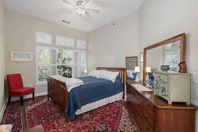 bedroom with a towering ceiling and ceiling fan