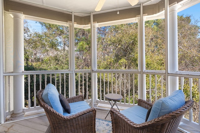 sunroom / solarium featuring ceiling fan