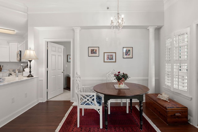 dining space with crown molding, dark wood-type flooring, and ornate columns