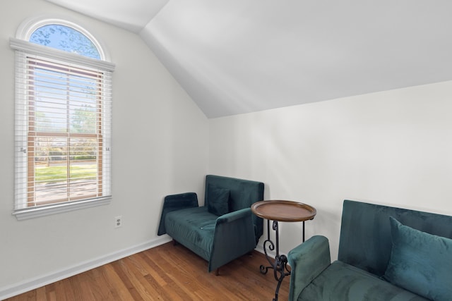sitting room with wood finished floors, baseboards, and lofted ceiling