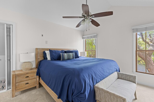 carpeted bedroom with baseboards, a ceiling fan, and vaulted ceiling