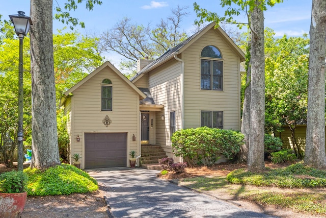 traditional home with an attached garage and driveway