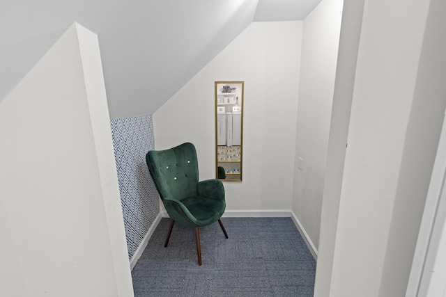 sitting room with baseboards and vaulted ceiling