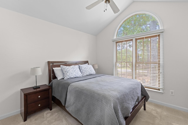bedroom with baseboards, a ceiling fan, vaulted ceiling, and light carpet