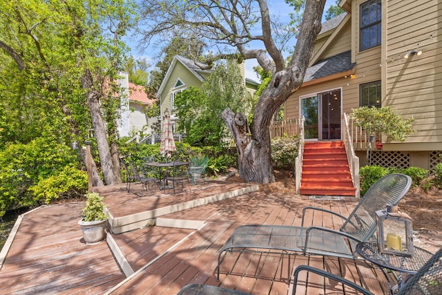 wooden terrace featuring outdoor dining space