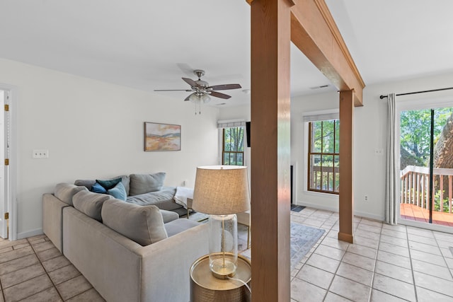 living room featuring ceiling fan, baseboards, and light tile patterned floors