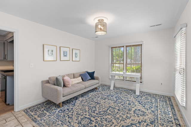 living area with visible vents and baseboards