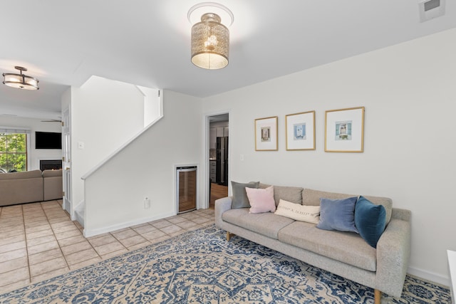 living room with tile patterned floors, baseboards, and visible vents