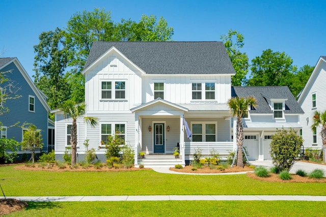 modern farmhouse style home with a garage, concrete driveway, a front lawn, and board and batten siding