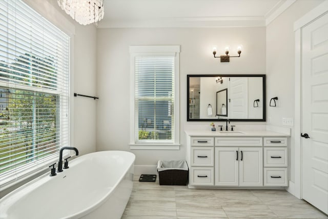 full bathroom with a soaking tub, plenty of natural light, ornamental molding, and vanity