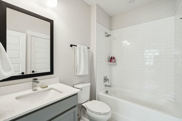 full bath with bathtub / shower combination, vanity, and toilet