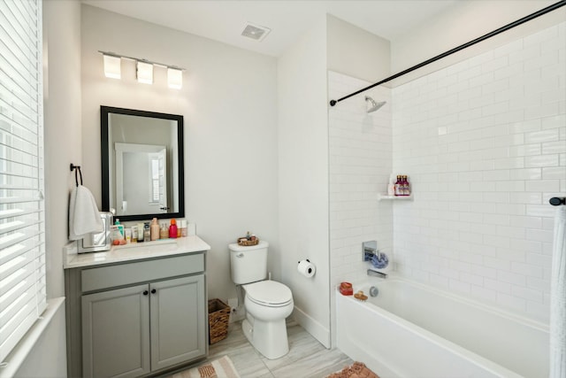 bathroom featuring shower / tub combination, toilet, visible vents, vanity, and baseboards