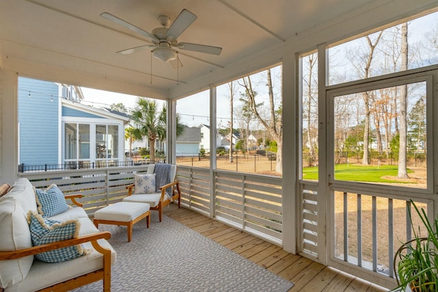 sunroom / solarium with a ceiling fan